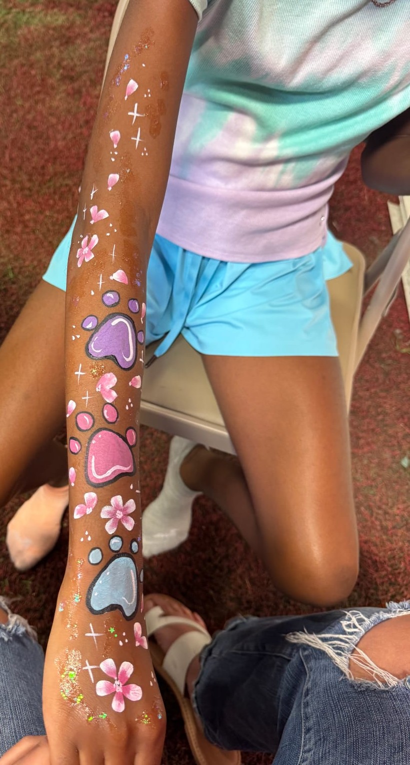 Paw print arm painting at a Texas kids party