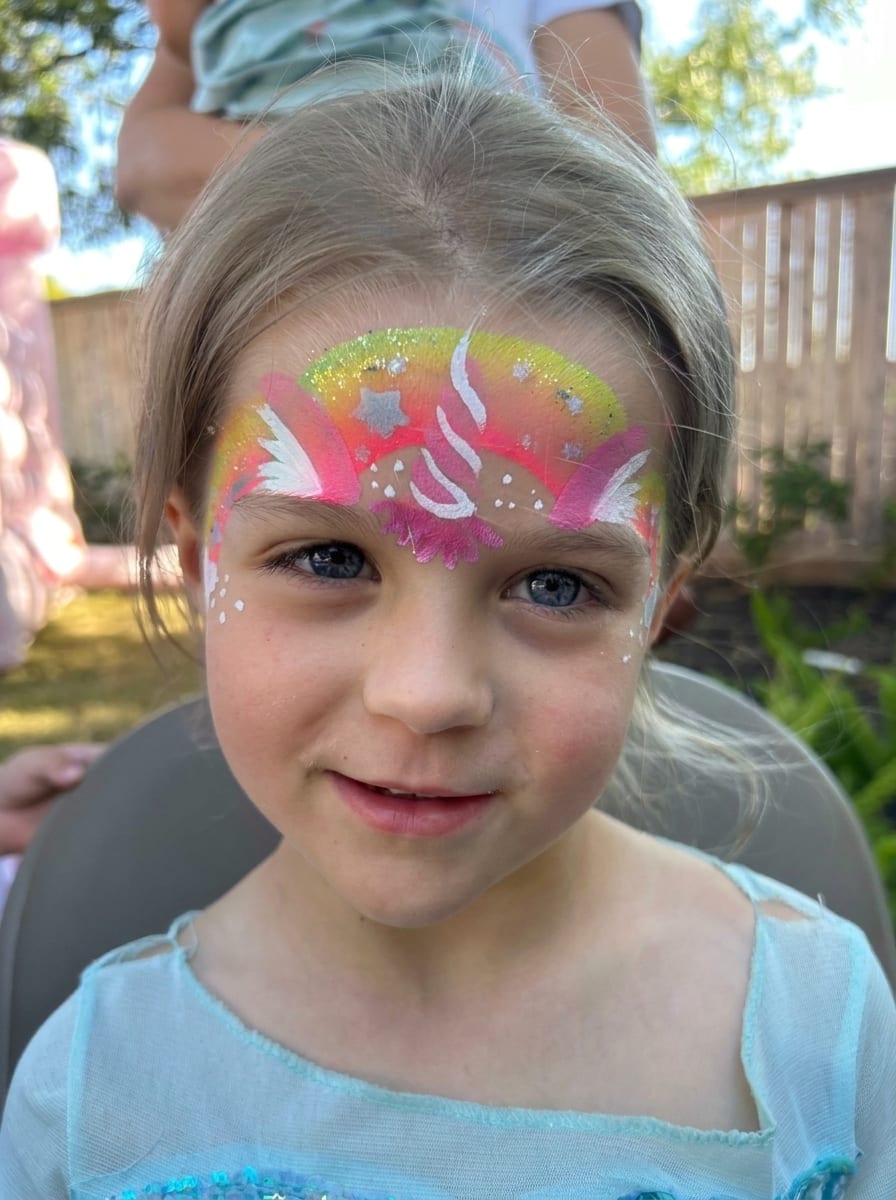 Unicorn face painting on a child at a Texas party