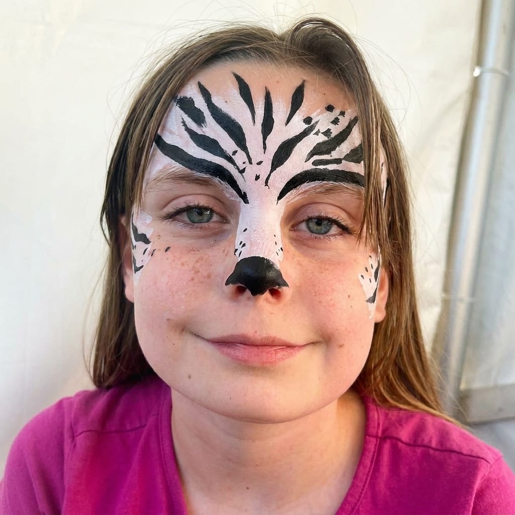 White leopard face painting on a child at a Texas party